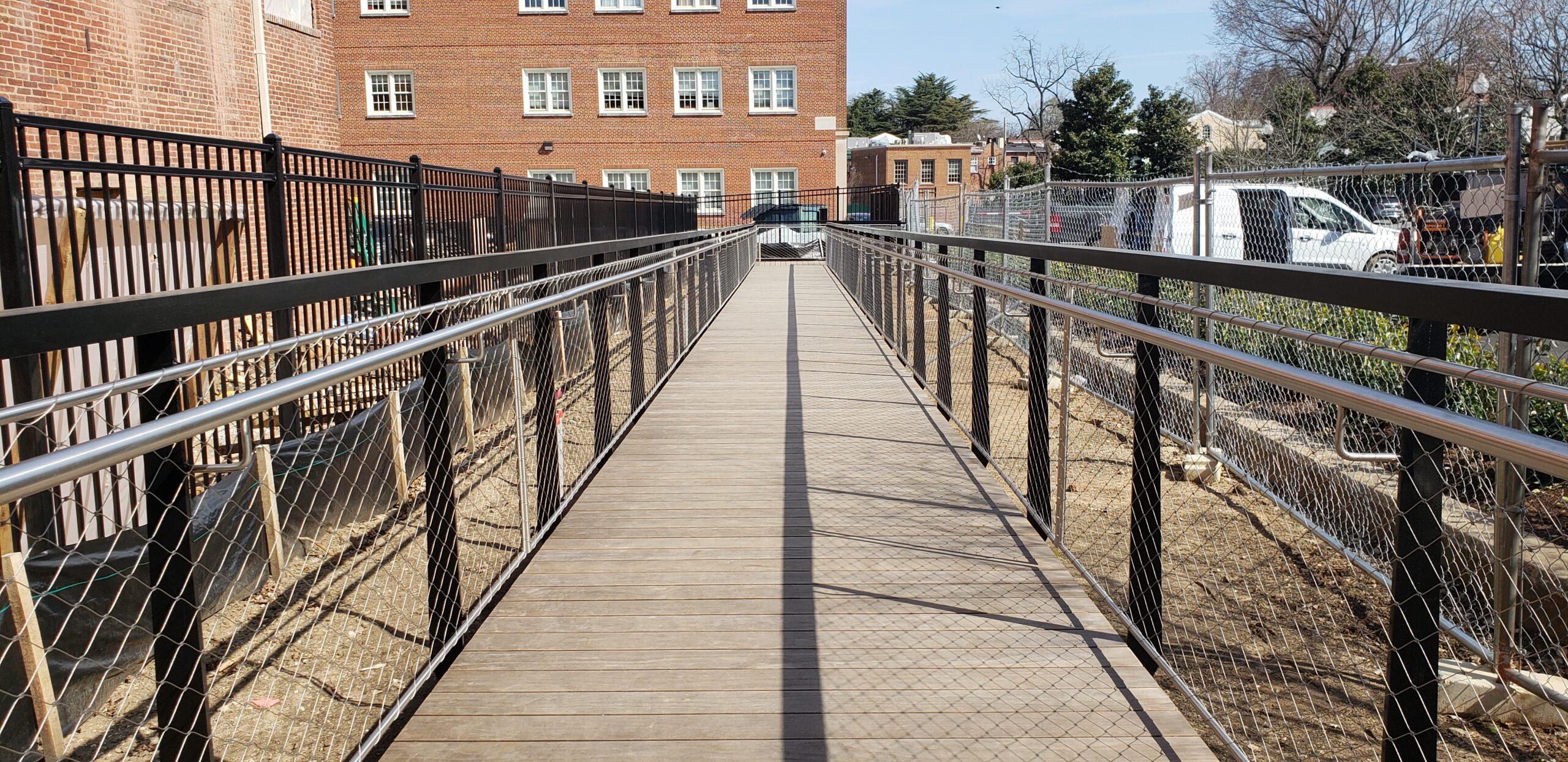 Commercial accessibility upgrade with an accessible custom ramp and stainless steel mesh railings
