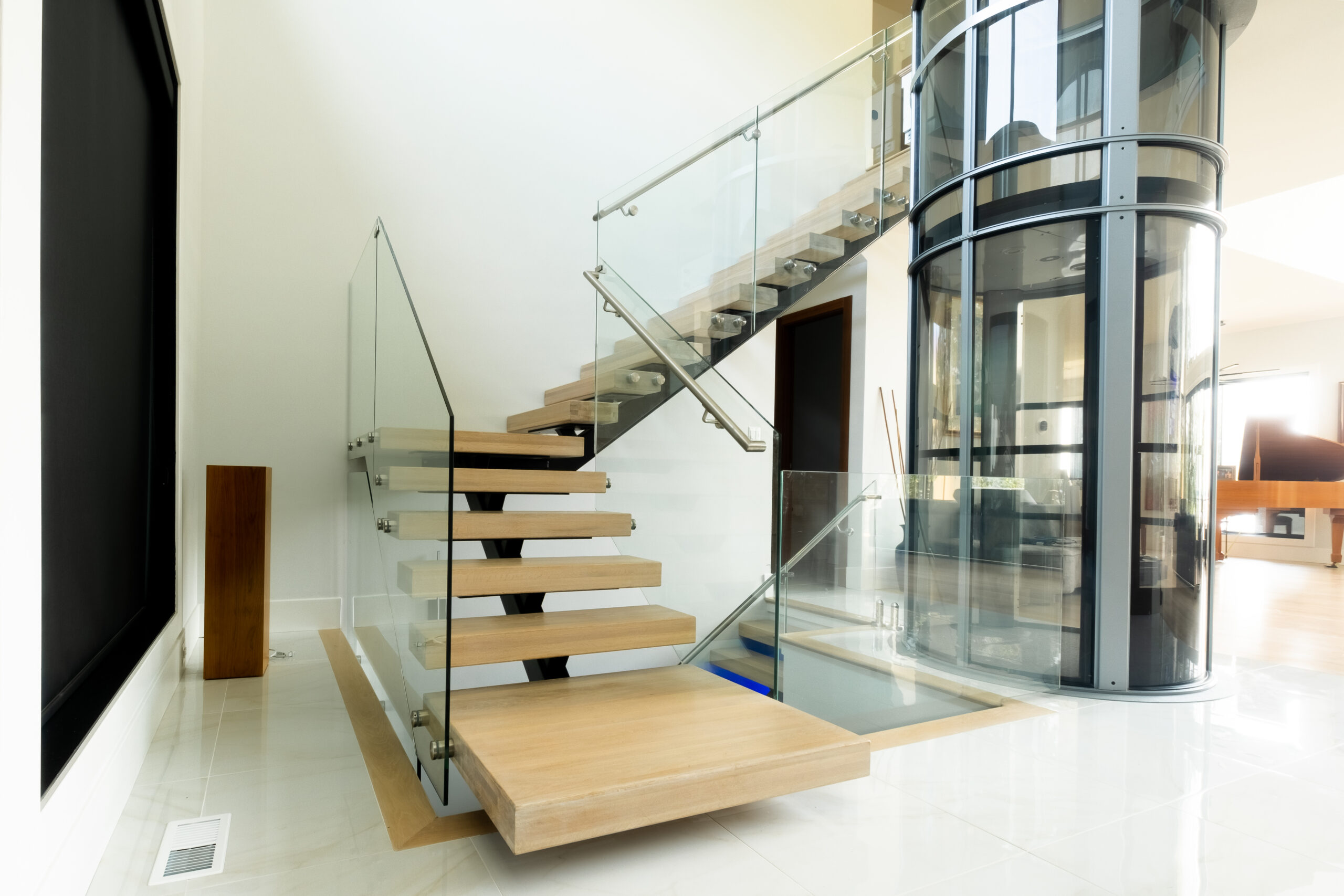 Custom home interior in Potomac, VA featuring a one stringer stair and glass railing system