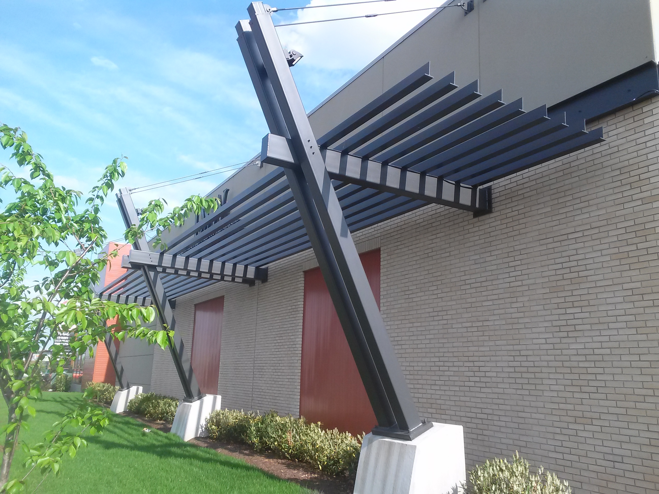ANBIZA custom steel slat sunshade canopy on a commercial building exterior
