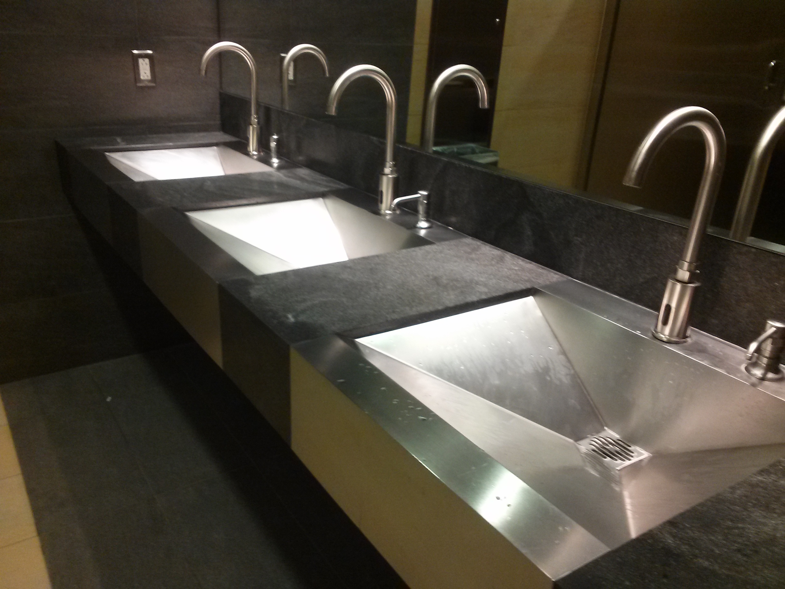 ANBIZA dark stone countertop with integrated stainless steel trough sinks and faucets