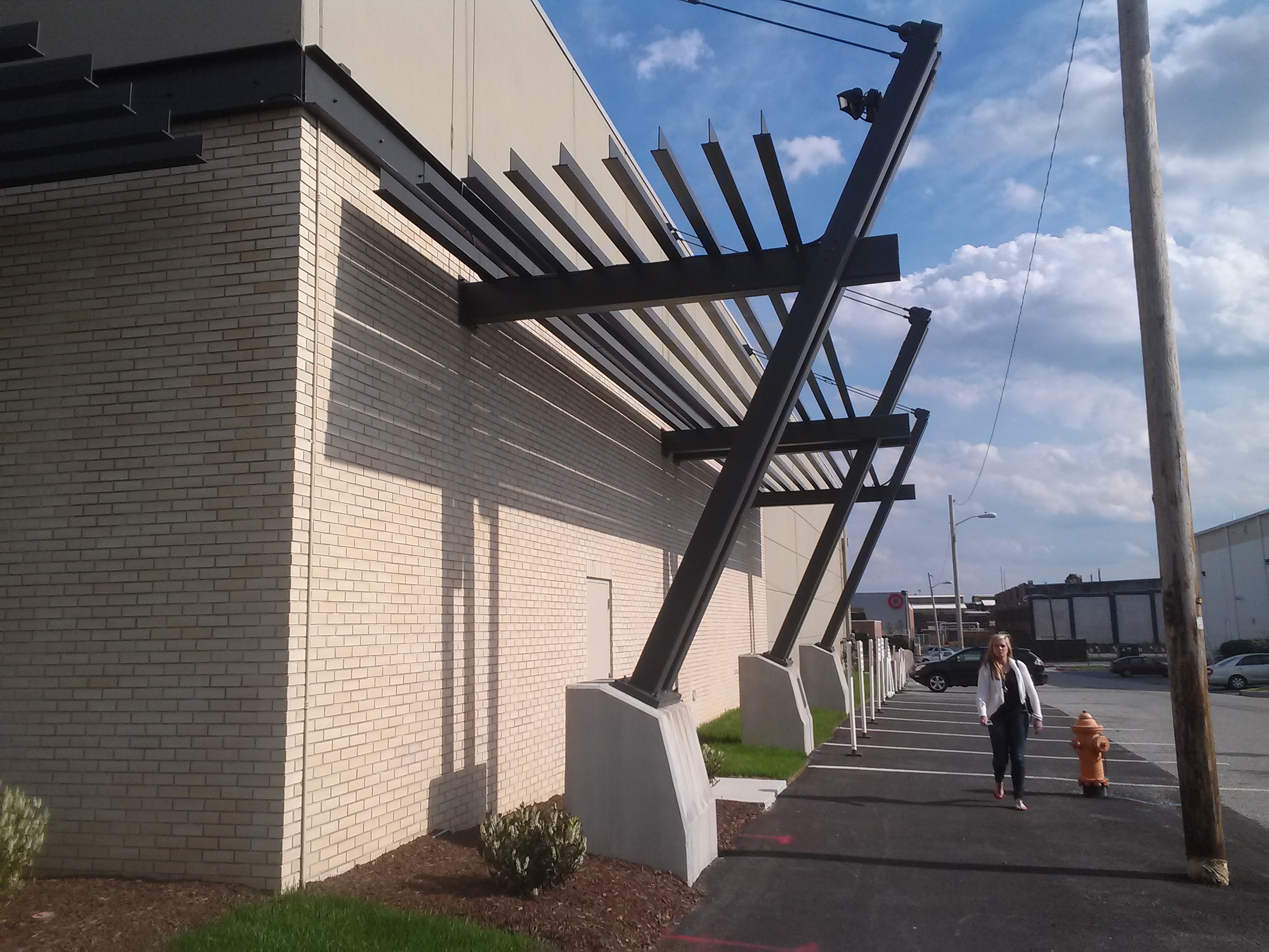 ANBIZA architectural steel canopy running along a commercial building facade